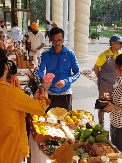 A customer at a fruit stall, showing the direct interaction with vendors.