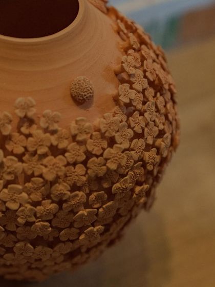 Here is the floral vase after its first firing, known as a bisque. The intricate details of the unglazed clay flowers are so beautiful on their own, it almost feels a shame to glaze it.