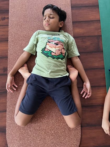 Tiny toes, mighty poses. This little one shows us the flexibility and peace found in Supta Virasana (Reclined Hero Pose).