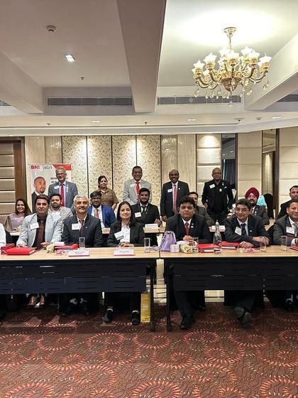 A group photo from a BNI networking event. Connecting with other professionals helps me understand the specific wellness needs of different industries so I can tailor my corporate programs effectively.