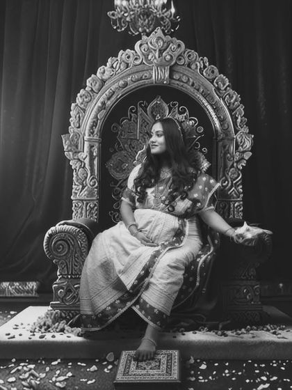 Embodying the spirit of the goddess, this black and white portrait captures the divine essence of motherhood in a powerful, regal setting.