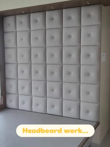 A floor-to-ceiling, wall-to-wall headboard I created for a client. The grid of square, button-tufted panels adds a sense of luxury and comfort to the bedroom.