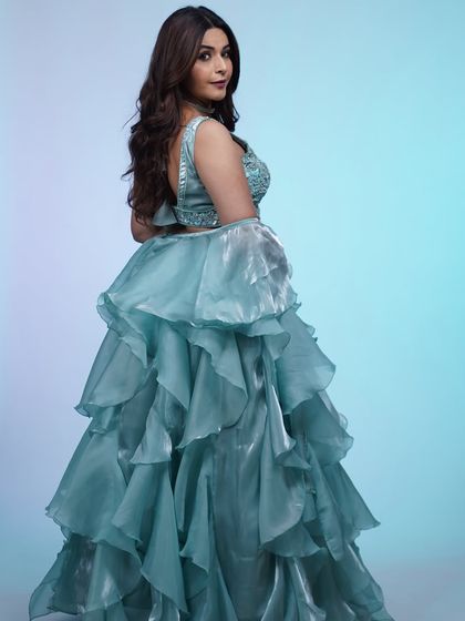 The back of this sky-blue lehenga is just as beautiful, with a simple strap design that complements the voluminous ruffled skirt.