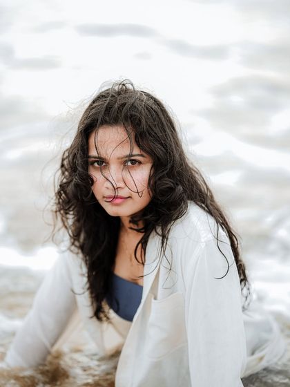 A striking portrait with a direct and powerful gaze. The simplicity of the setting allows the model's expression to be the complete focus.