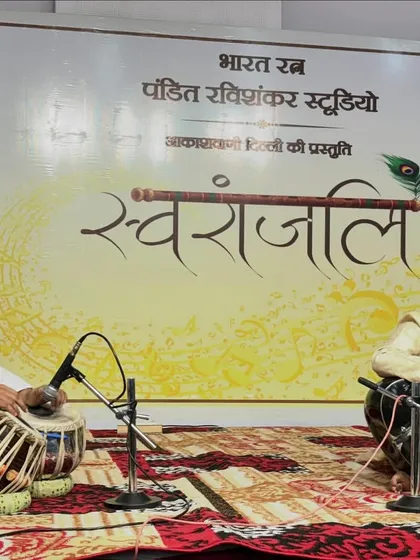 Sharing a smile with my co-artist on stage at Akashvani Delhi. The chemistry between musicians is essential for a captivating live performance.