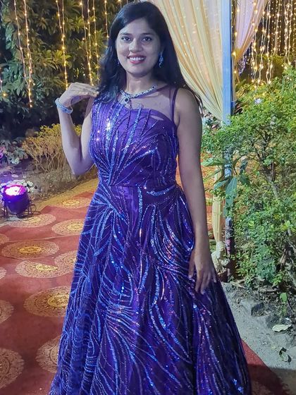 This beaded sequin ball gown in a mix of purple and lavender is a true showstopper. It's available to rent or buy for your birthday or wedding celebration.