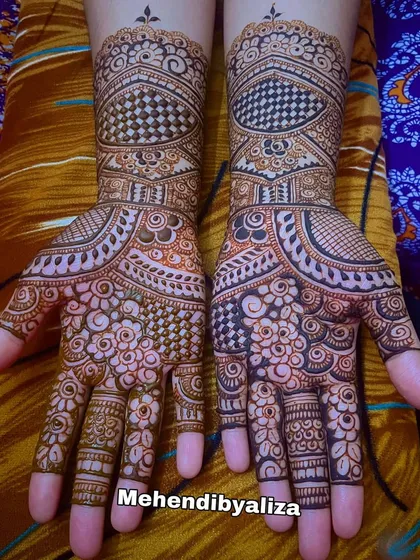 An Eid henna design with checkerboard patterns and floral motifs.