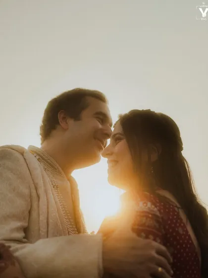 A sun-kissed portrait where the couple shares a happy, intimate moment. The golden light wraps around them, highlighting their smiles and the easy comfort they find in each other.