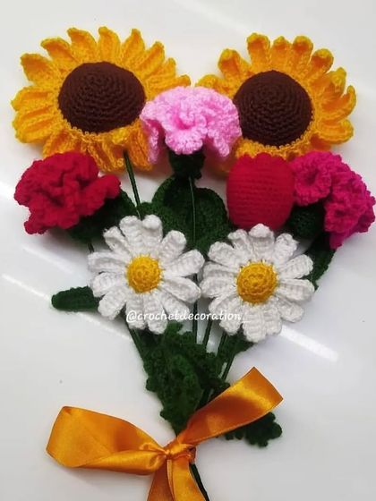 A bright and cheerful mixed flower bouquet featuring two sunflowers, daisies, carnations, and tulips. This arrangement is a burst of color and joy, perfect for any celebration.