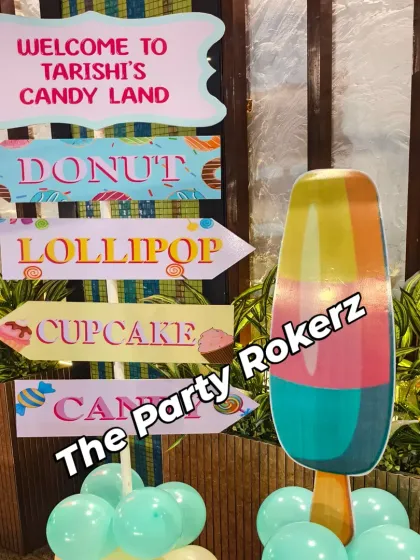 A fun "Welcome to Candyland" directional signpost, pointing the way to donuts, lollipops, and cupcakes.