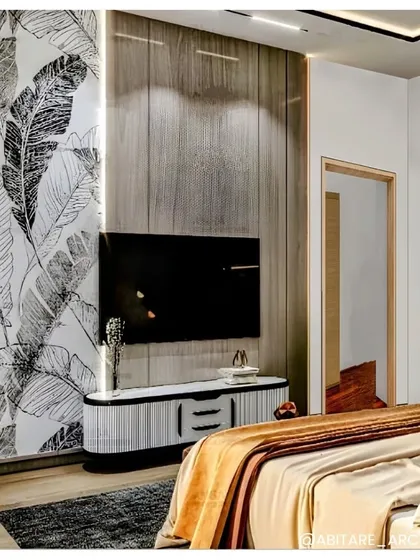 In this cozy bedroom, I used a combination of wood-paneled and wallpapered accent walls to create a warm, layered look. The black and white botanical print adds a graphic element, balanced by the warm tones of the bedding.