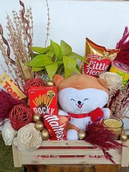 This is a great example of a versatile and charming hamper that works for any occasion. It includes a mix of snacks, a cute plush toy, and decorative dried florals, making it a delightful gift for team appreciation.