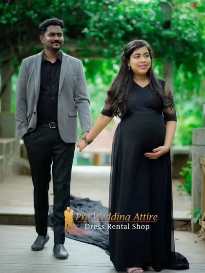 A classic black flowy gown is a must-have for a timeless couple's maternity shoot. The dress drapes beautifully, and its simplicity allows the happy connection between the parents-to-be to shine.