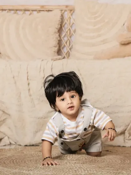 Another angle of this adorable baby exploring the boho set. The wicker furniture adds a lovely rustic touch.