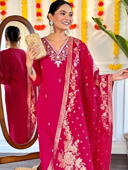 This rani pink kurta set is a classic festive look. The jacquard woven dupatta and thread embroidery on the kurta make it rich and celebratory.
