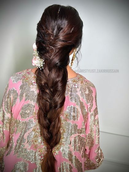 A classic, thick braid with a twisted crown, perfect for a traditional event. This style is elegant and timeless, and can be adorned with flowers or accessories.