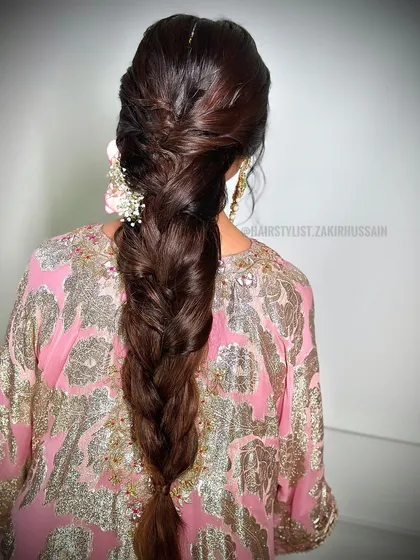 A classic, thick braid with a twisted crown, perfect for a traditional event. This style is elegant and timeless, and can be adorned with flowers or accessories.