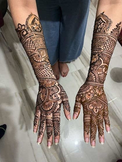 This top-down view shows the full scope of an elbow-length bridal design. The patterns are intricate and dense, ensuring a stunning look from every angle.