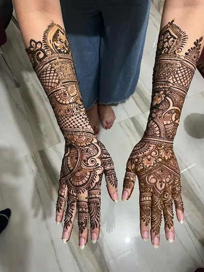 This top-down view shows the full scope of an elbow-length bridal design. The patterns are intricate and dense, ensuring a stunning look from every angle.