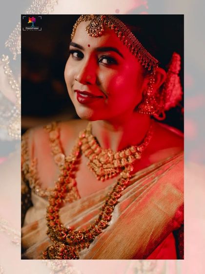 A dramatic bridal portrait with red lighting, highlighting the bride's beautiful features and traditional gold jewelry. This technique adds a bold and cinematic feel.