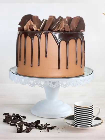 A classic chocolate drip cake, topped with a mountain of Oreos and KitKats. This is a timeless favorite for chocolate lovers of all ages.