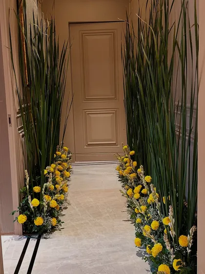 We created a beautiful walkway for a housewarming event using tall grasses and a bed of marigolds, guiding guests into the newly blessed home.