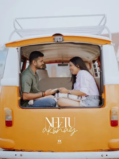 A beautifully framed photo from inside the van, capturing the couple's happy interaction and the fun, adventurous theme.