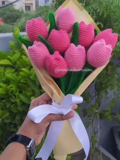 A beautiful, full bouquet of nine handmade pink crochet tulips, wrapped in elegant paper with a white ribbon. This everlasting arrangement is one of our most popular gifts for birthdays and anniversaries.