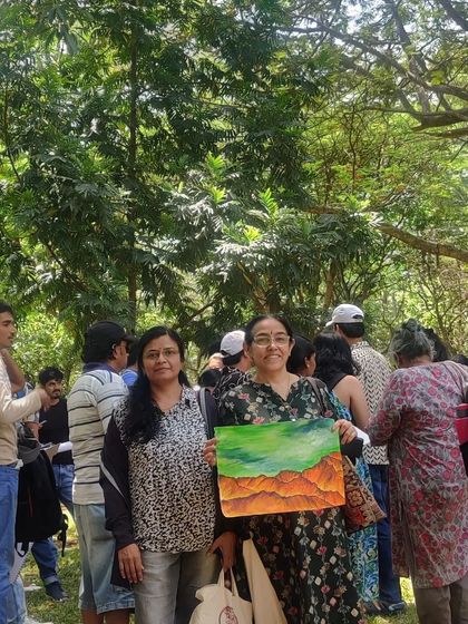A group of us admiring a beautiful landscape painting created during the session.