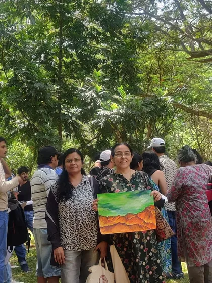 A group of us admiring a beautiful landscape painting created during the session.