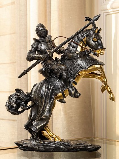 Another version of my medieval knight sculpture, this one holding a lance. The combination of the dark armor and gold accents on the horse creates a powerful and heroic table decor piece.
