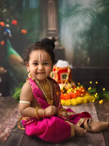 Such a cheeky and adorable smile from our little Krishna. His playful energy made this traditional Janmashtami photoshoot so much fun.