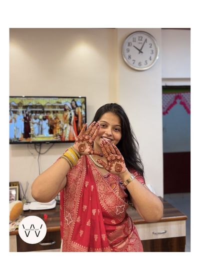 A happy client showing her Teej henna, a simple design that's full of love and magic.