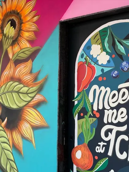 Another detailed shot connecting the sunflower mural with the kitchen door art, showing the consistent color palette and style.
