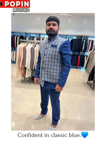 This client is wearing a blue Indo-Western suit with a grey plaid waistcoat. It's a great example of how I mix and match pieces to create a custom look.