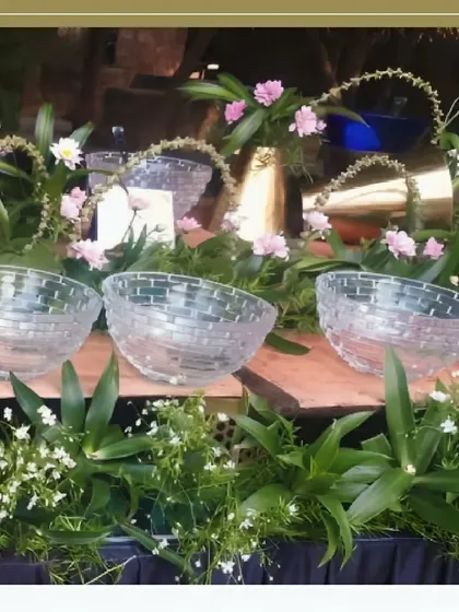 An example of our premium serveware, featuring textured crystal bowls set amongst fresh flowers and greenery for a salad or dessert station.