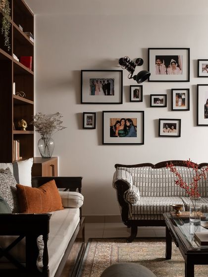 A home is a collection of memories, and this gallery wall is the heart of this living room. I worked with the family to arrange their cherished photographs, creating a personal story that unfolds across the wall. It’s a living testament to shared laughter, milestones, and the moments that matter.