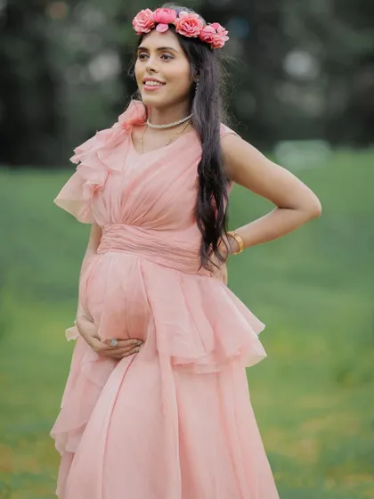 A close-up shot capturing the happy expression and glowing look of this mom-to-be, complemented by a floral crown.