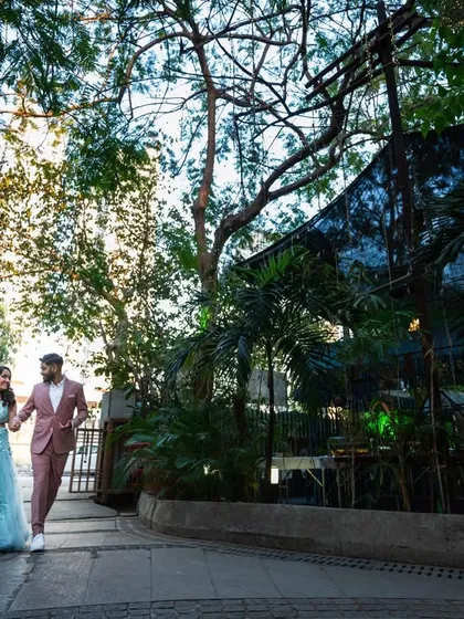 A wide shot of the couple walking, showing off their outfits and the location. This helps to set the scene for their story.