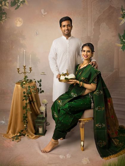 A timeless portrait of a couple in traditional Maharashtrian attire. The husband holds a plate with a Krishna idol, adding a spiritual and serene element to their maternity shoot.
