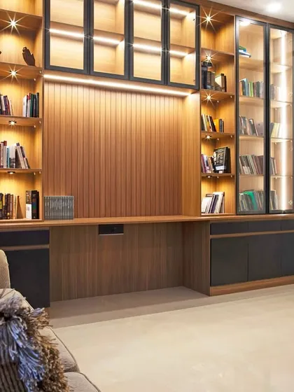 Sometimes all you need is a quiet corner. This library is designed as a sanctuary, with warm wood tones and soft lighting to calm the mind.