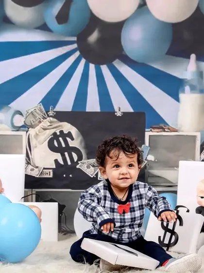A full setup view of the 'Boss Baby' theme, showing the creative backdrop and all the fun, money-related props we use.