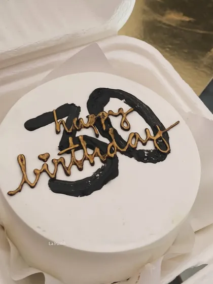 A bold and stylish bento cake for a 30th birthday, featuring black brushstrokes and elegant gold script.