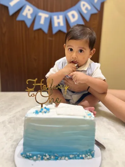 Look at this little cutie digging right in! A year is too long to wait for cake, so we celebrated his half birthday in style.