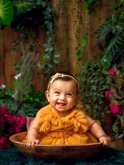 A big, happy smile from our secret garden. The rich colors and textures make this a visually captivating milestone photo.
