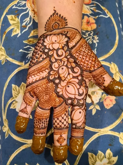 Another design from the busy Teej season. This one features a lovely combination of flowers and leaves, with filled fingertips for a traditional touch.