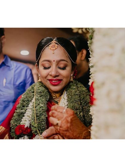 A tender moment during the ceremony. The bride's makeup is soft and romantic, with a focus on her expressive eyes.