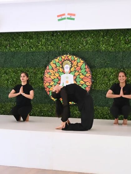 Our instructors demonstrate a beautiful sequence combining Ustrasana (Camel Pose) with Malasana (Garland Pose). This highlights the grace and coordination developed through consistent practice.
