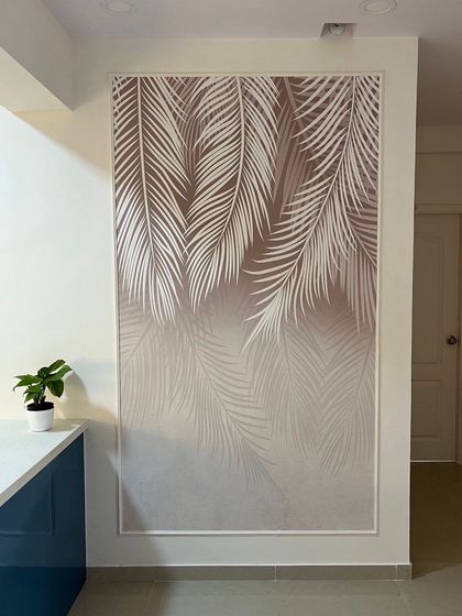 I often use large-scale wallpapers to turn a simple wall into a piece of art. Here, a beautiful palm leaf wallpaper panel adds a touch of nature and sophistication to the dining area adjacent to the kitchen.