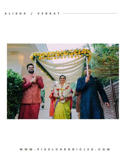 The bride's beautiful entrance under a floral canopy held by her brothers.